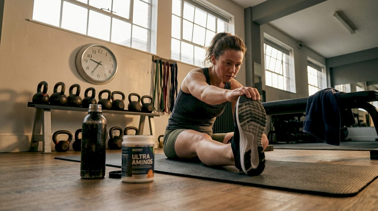 Woman stretching after workout in gym