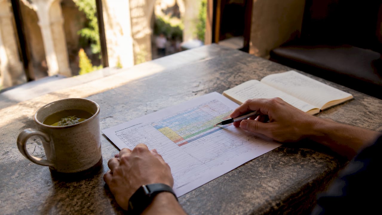 Hands reviewing sweat rate and electrolyte chart