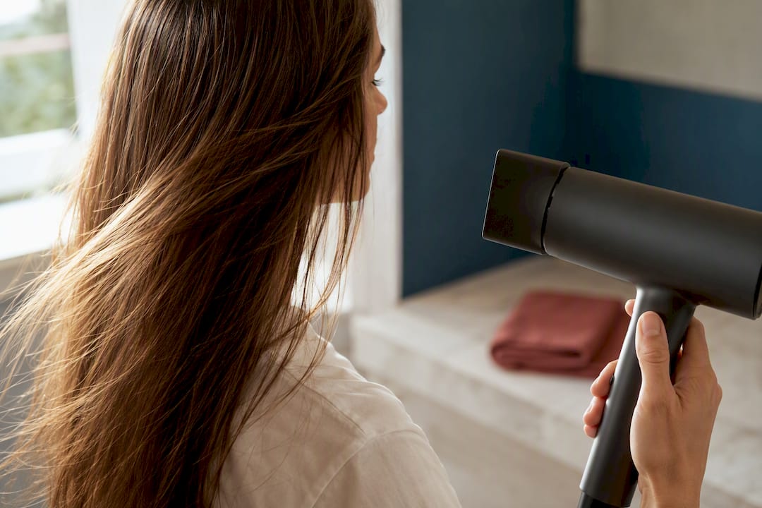 Hand holding hair dryer away from hair