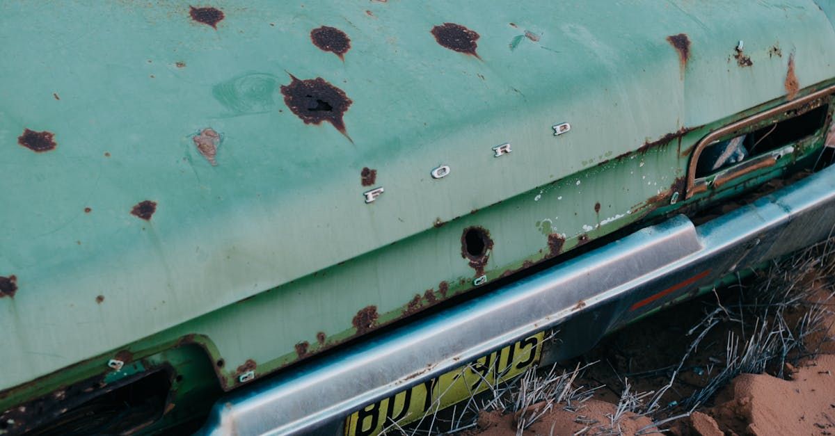 Man inspects car hail dents in British car park