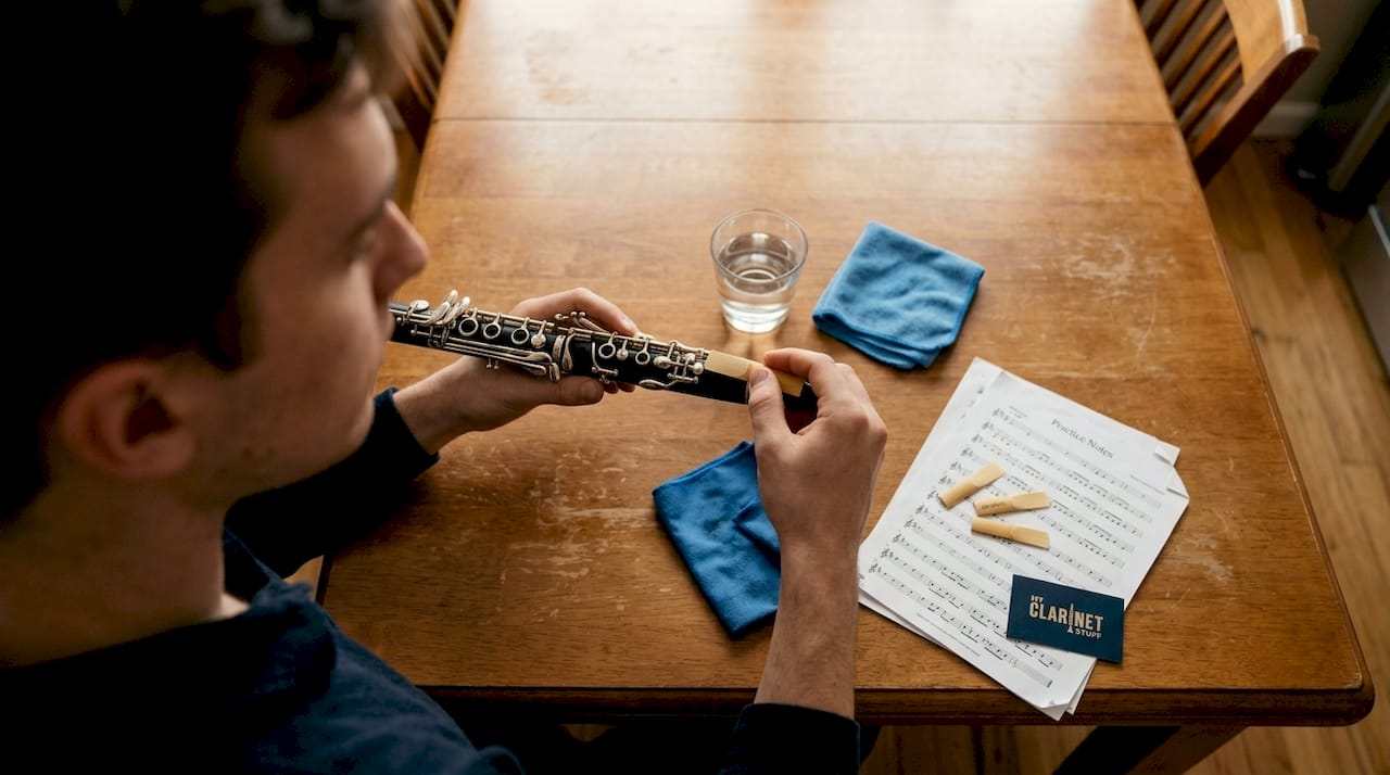 Clarinetist adjusting reed on kitchen table