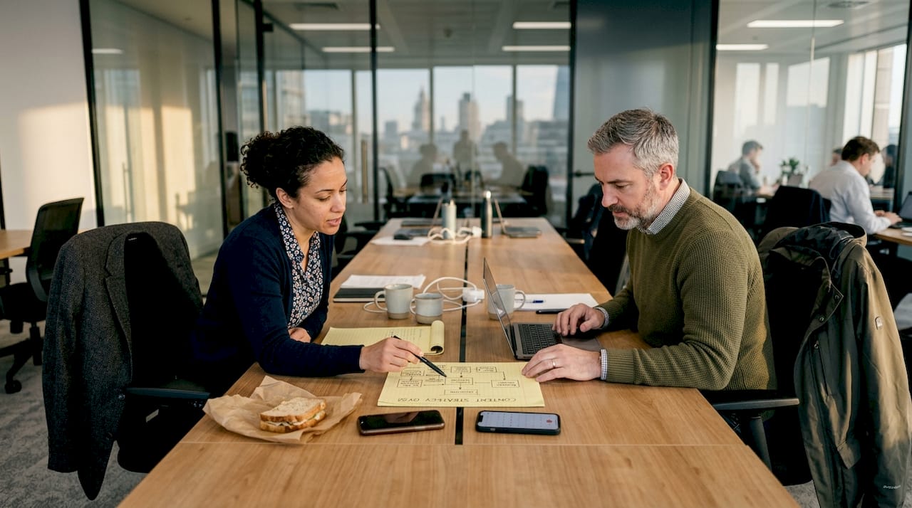 Colleagues discussing content strategy at desk