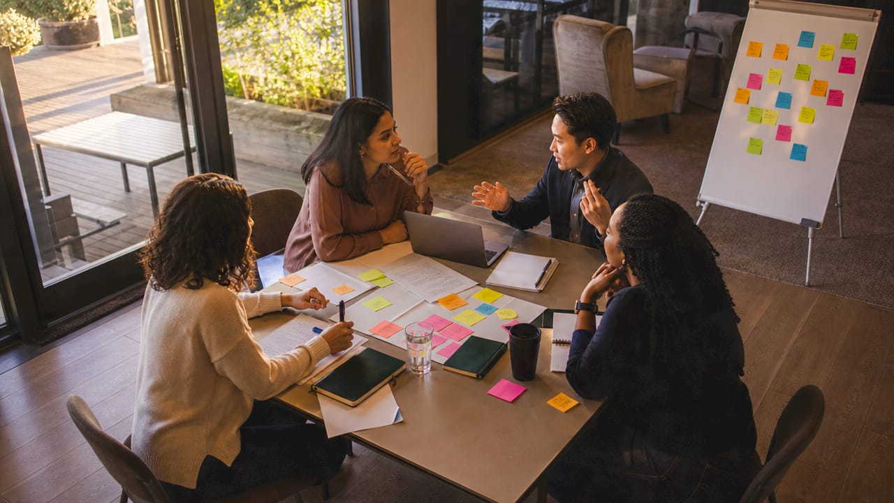 Legal aid staff collaborating in meeting room