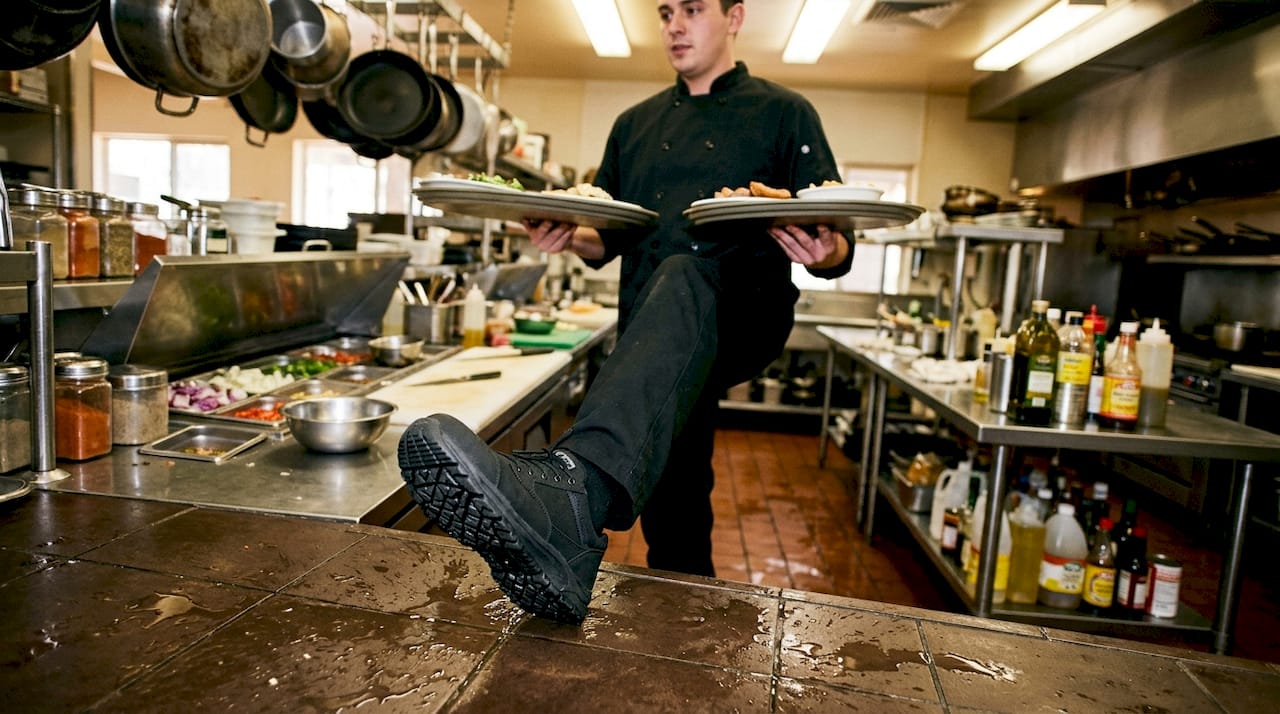 Worker wearing slip-resistant shoes in kitchen