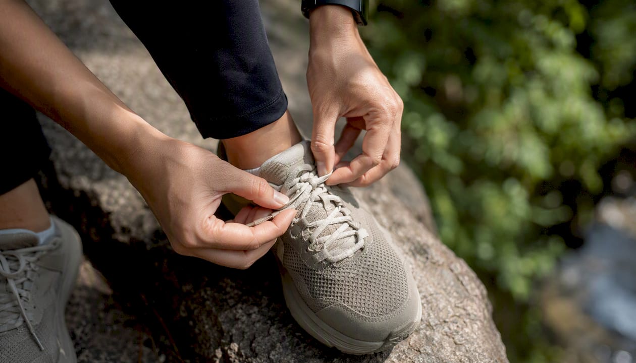 Hands tying secure shoe knot close-up