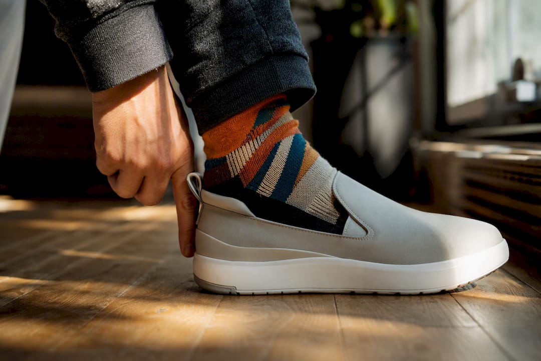 Foot slipping into sneaker showing fit