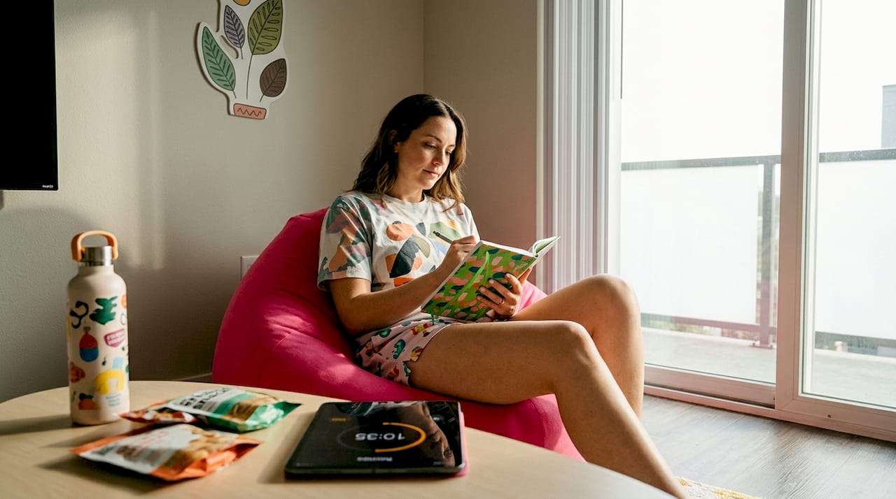 Woman writing cannabis edible dose journal