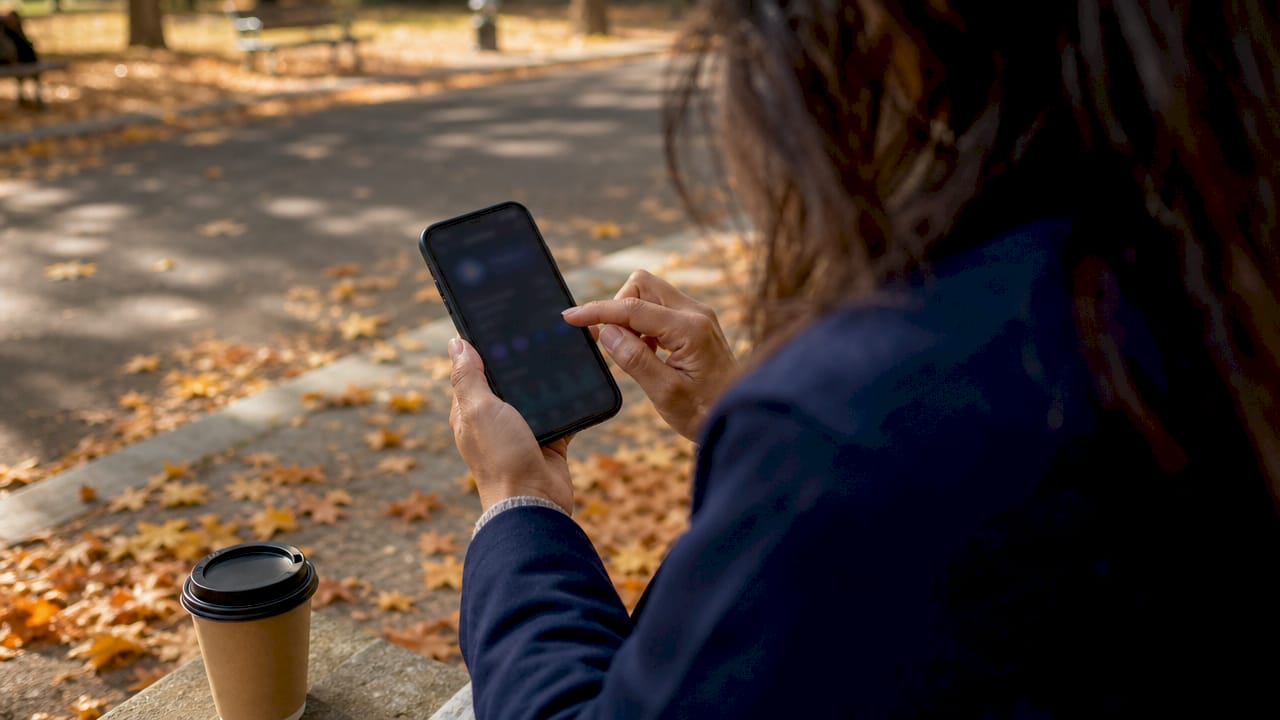 Hands scrolling customer retention dashboard on phone