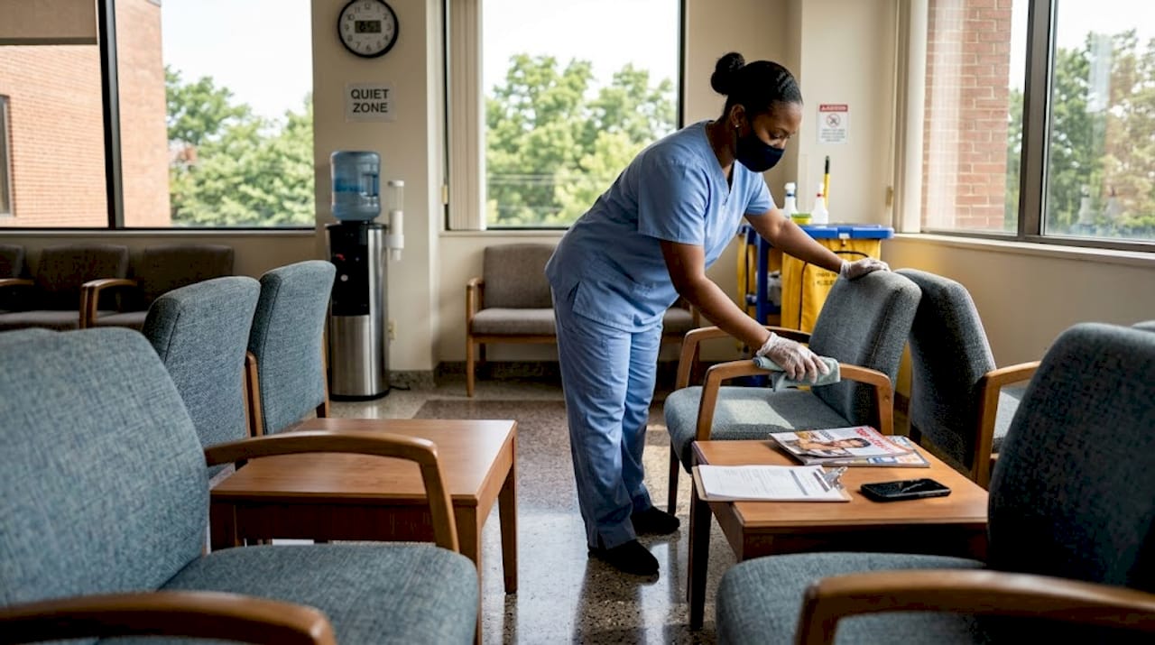 Staff cleaning doctor office waiting area chairs