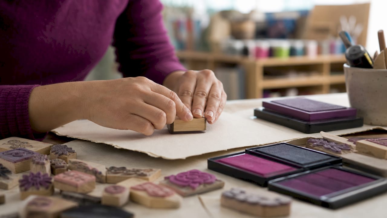 Hands stamping with custom hand-lettered rubber stamp