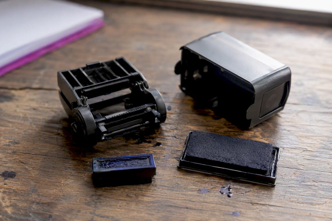 Disassembled self-inking stamp showing flip mechanism