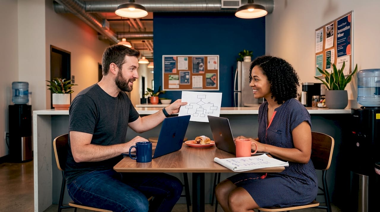 Founders sharing ideas in workspace kitchen