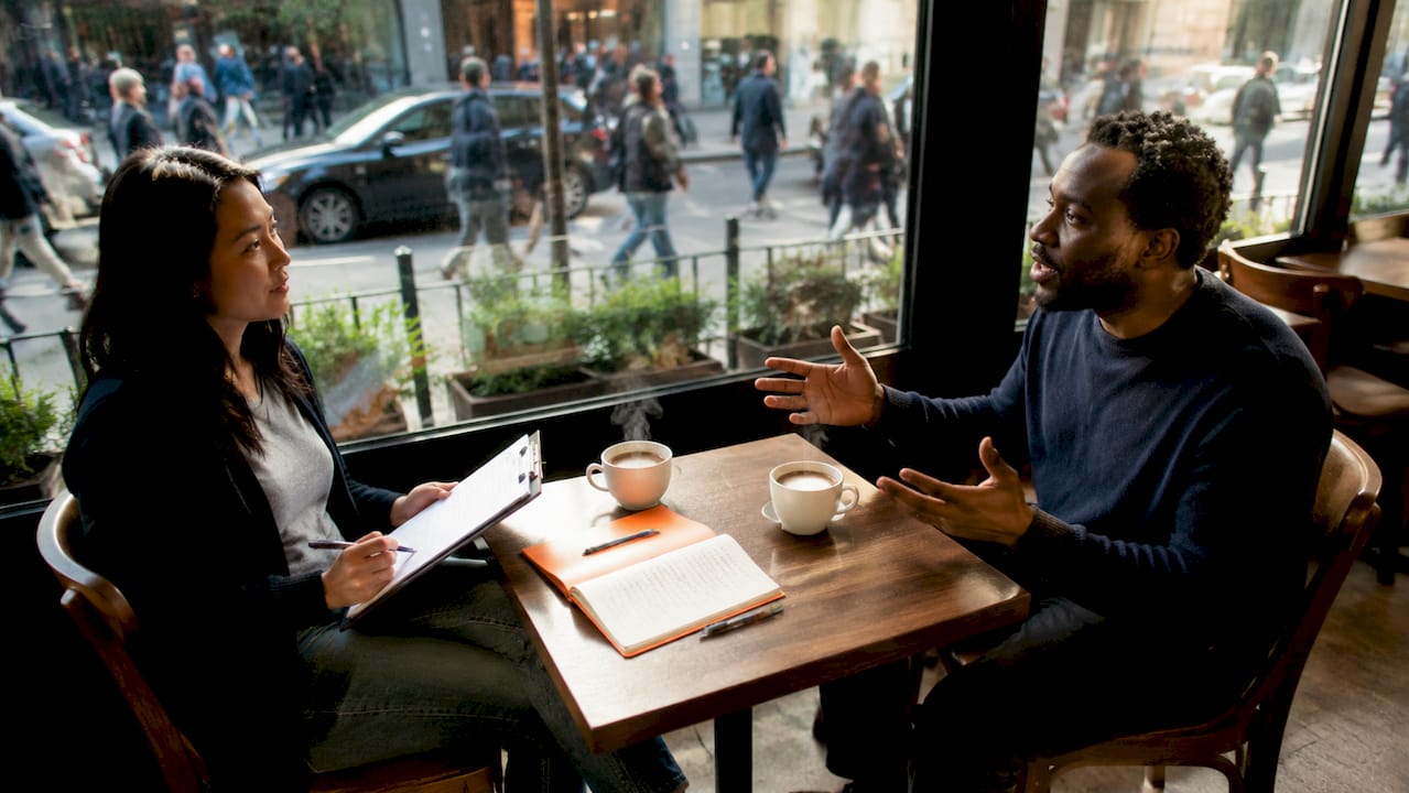 Founder interviewing customer in coffee shop