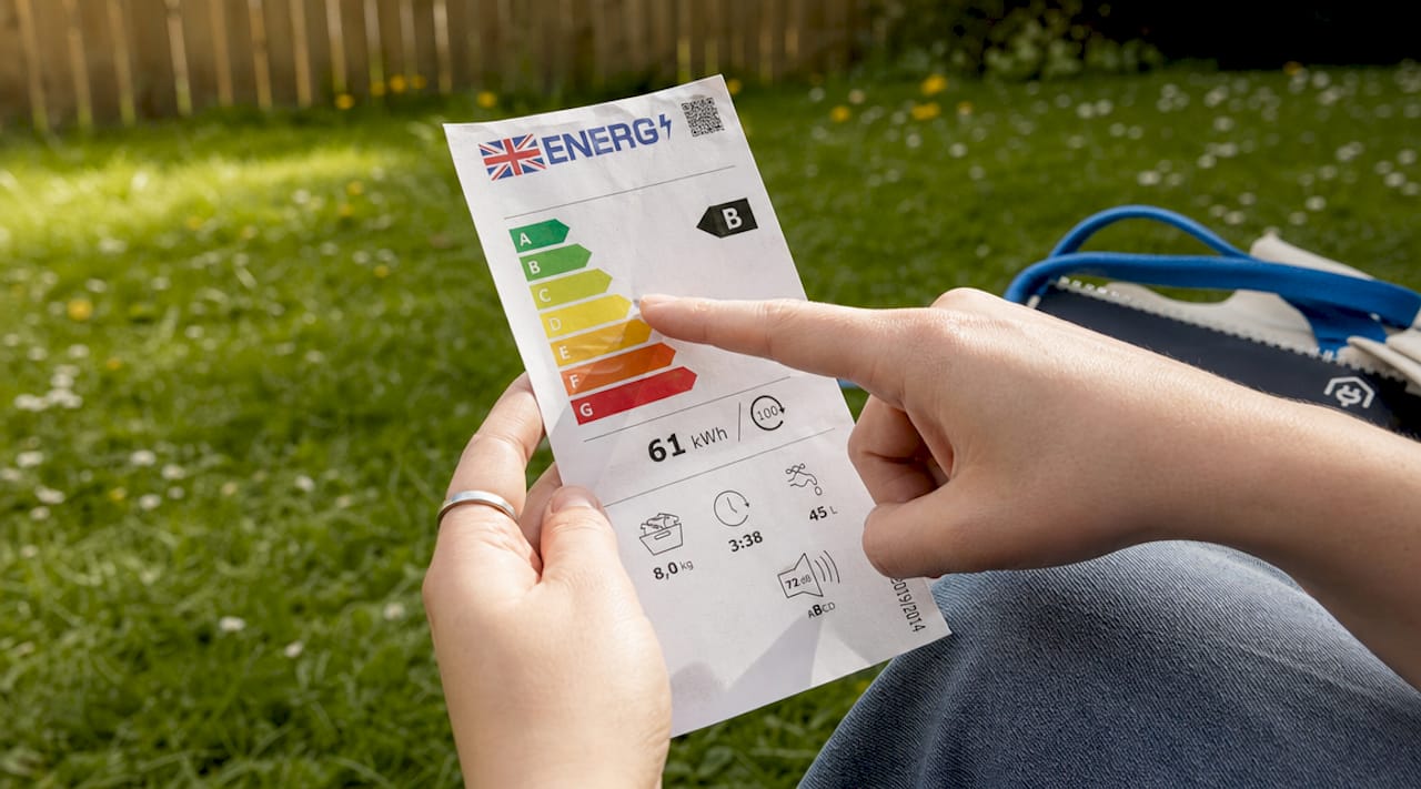 Close-up of hands examining energy label details