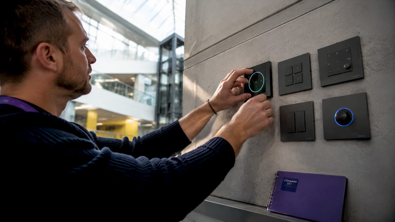 Hands adjusting LED lighting controls