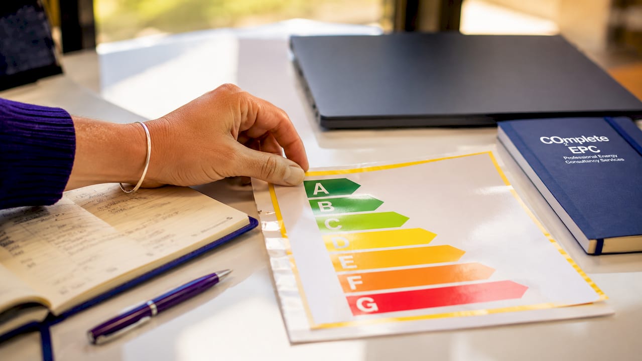 Hand holding EPC rating chart overhead view