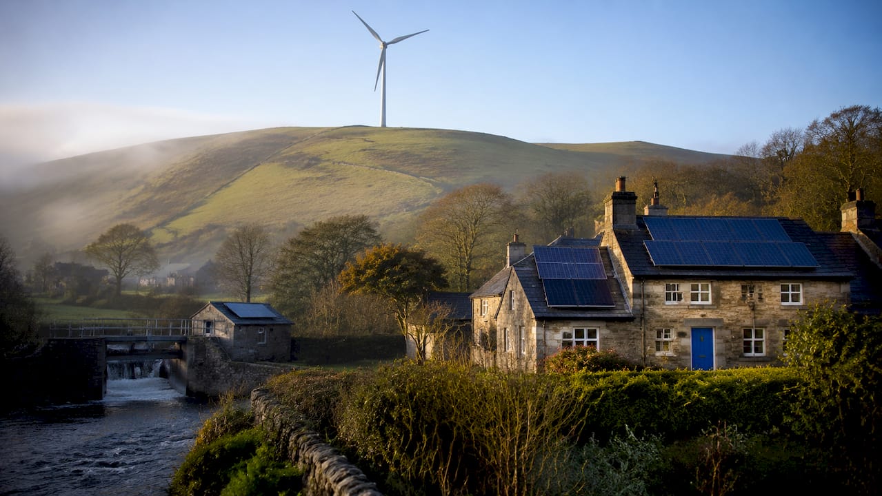 Landscape showing UK wind turbines, solar panels, hydroelectric