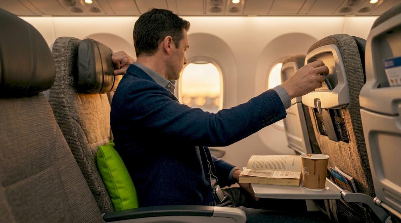 Passenger adjusts ergonomic travel seating on plane