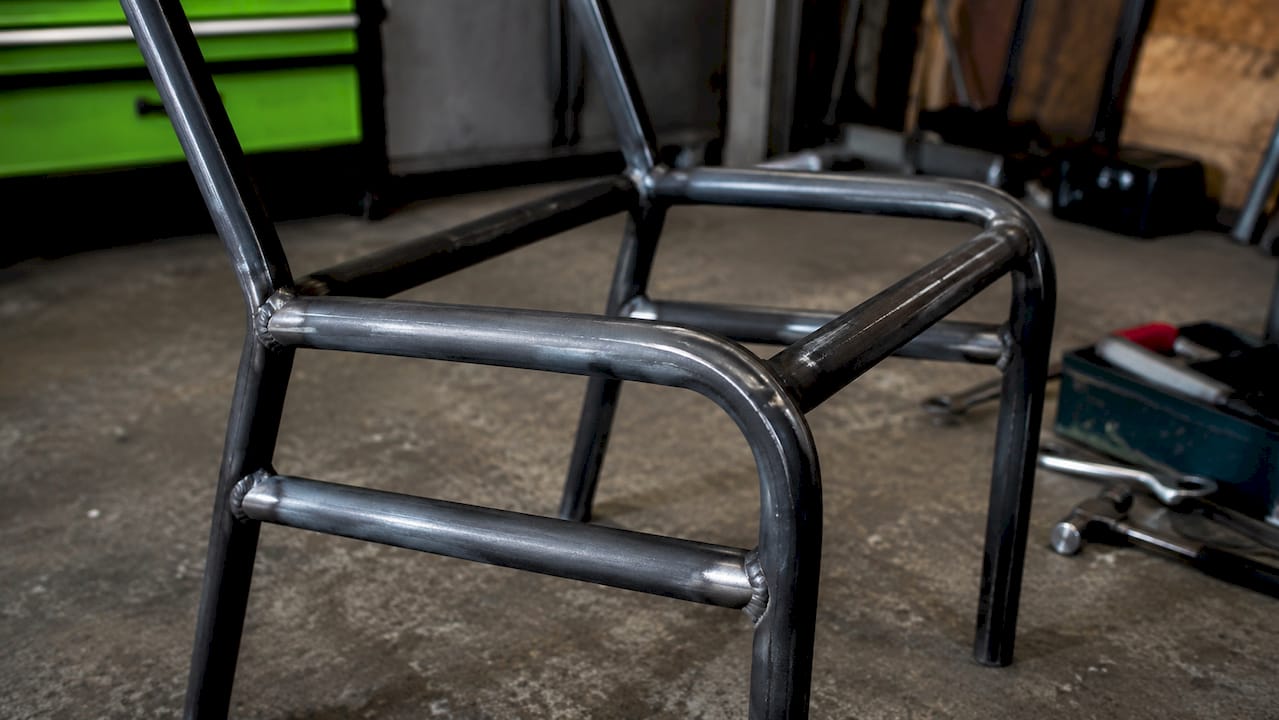 Close-up welded steel frame on reinforced chair