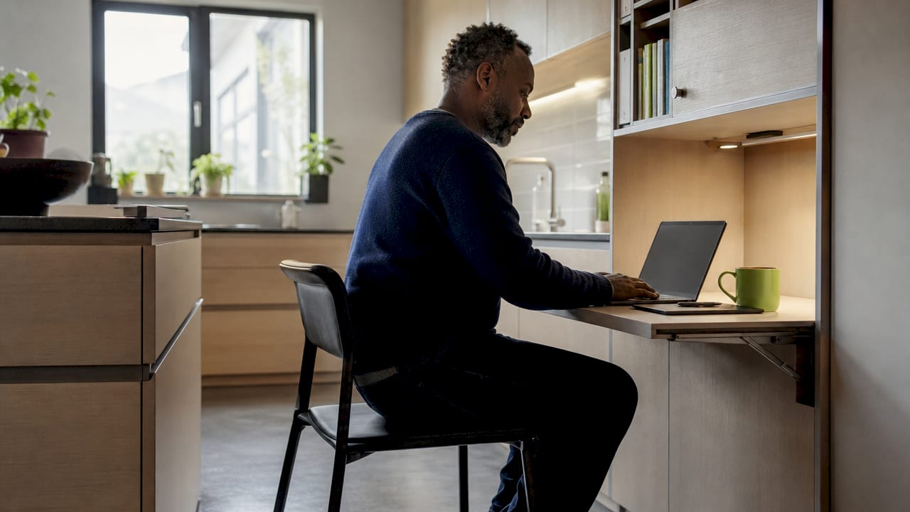Man unfolding compact multifunctional desk