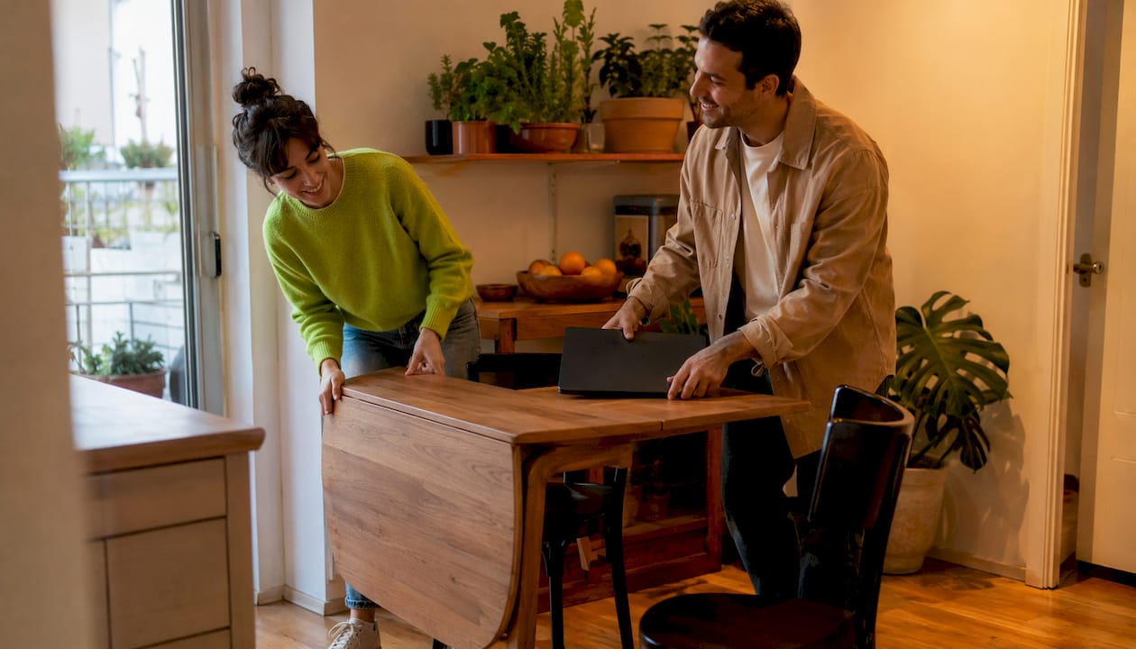 Couple using foldable compact table in kitchen nook
