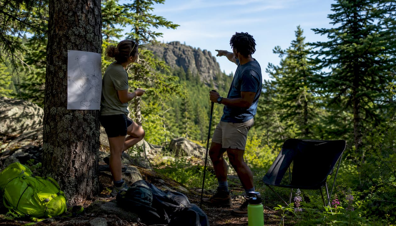 Campers planning campsite layout outdoors