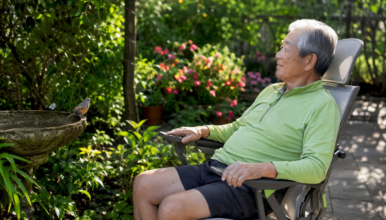 Man adjusting ergonomic outdoor chair