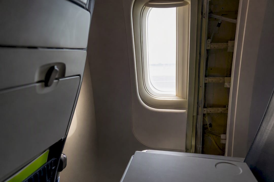 Airplane window offset from seat row