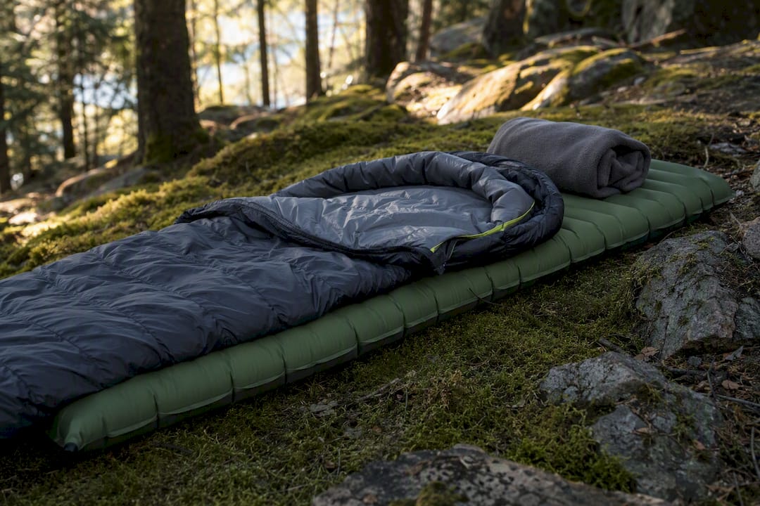 Sleeping bag setup on pad in forest