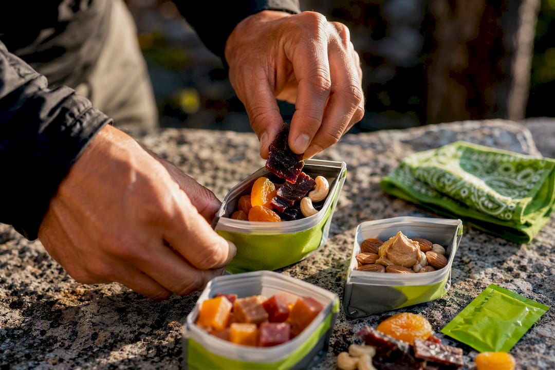 Hands portioning calorie dense trail snacks