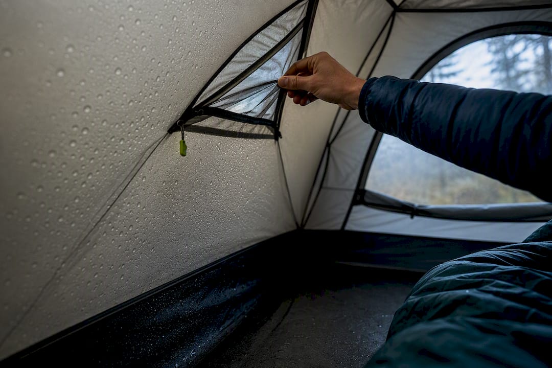 Camper opening tent vent near condensation