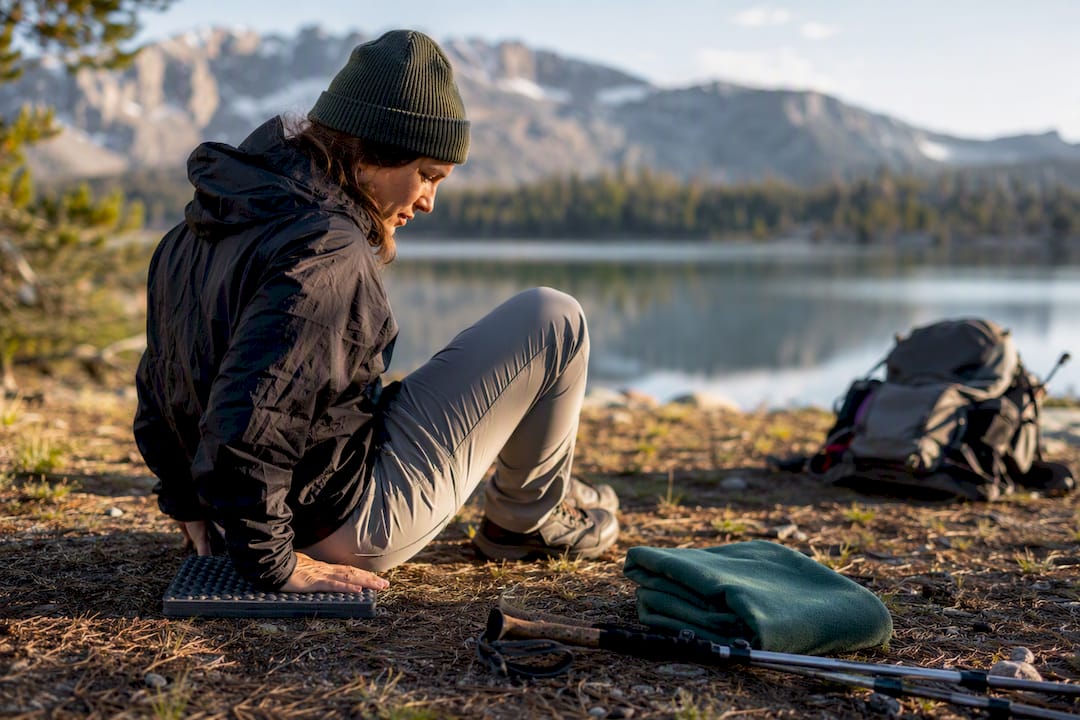 Hiker resting on lightweight foam sit pad