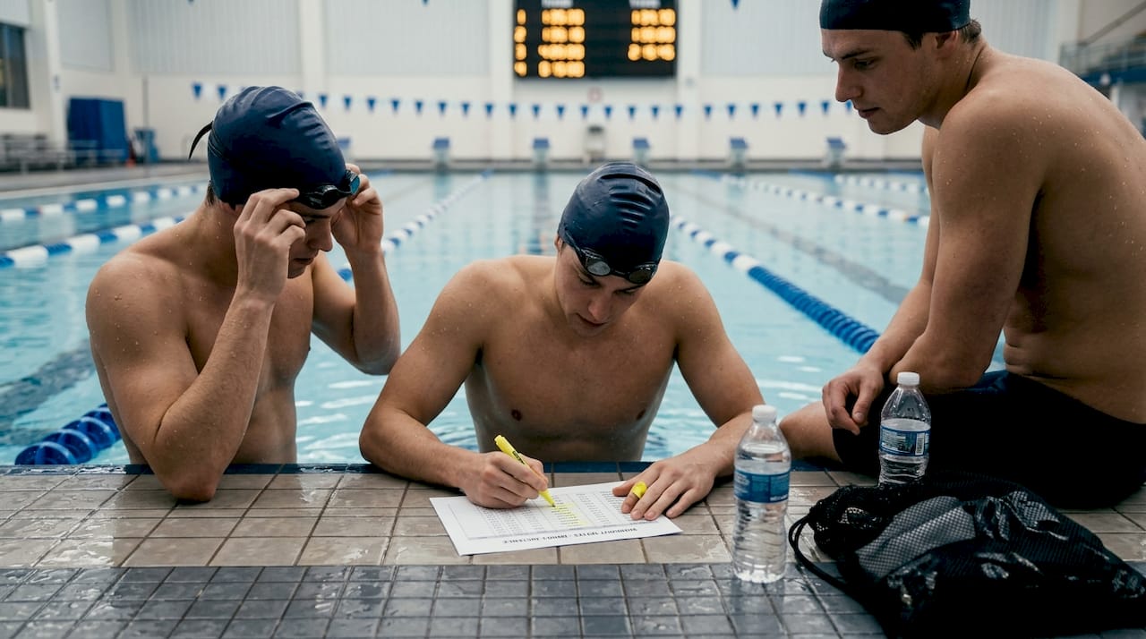 Swimmers discuss pacing before a race