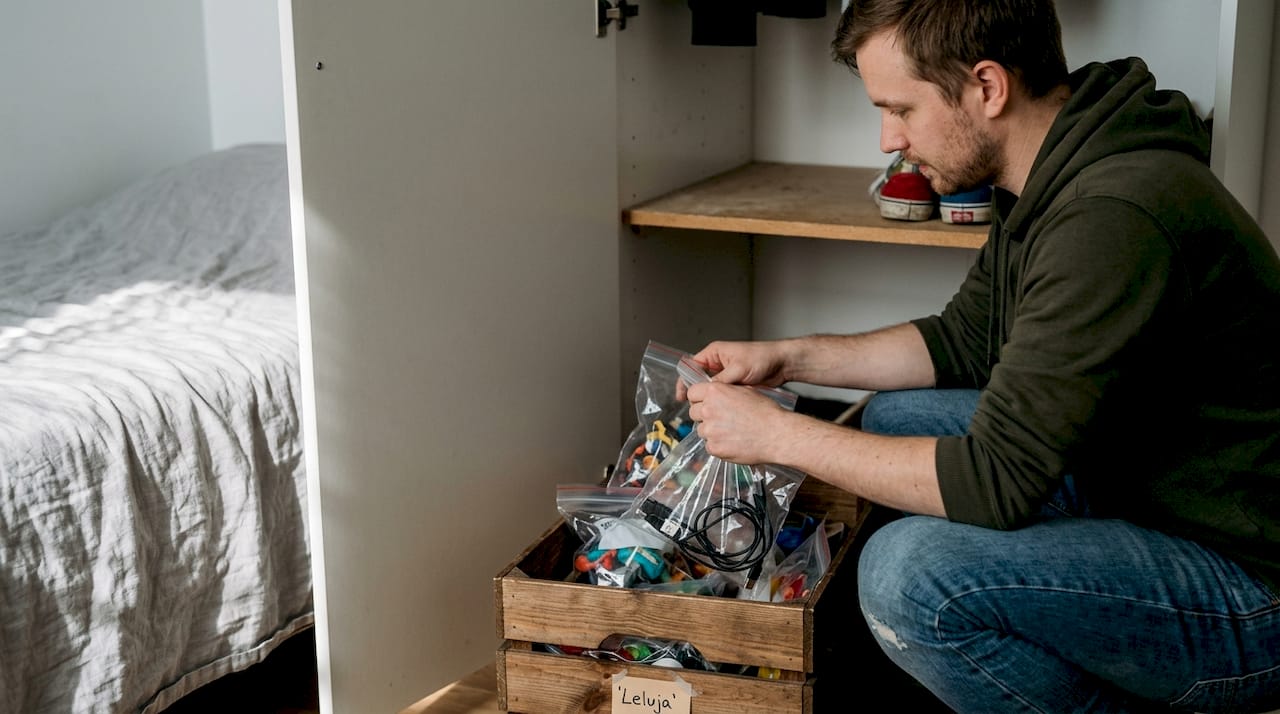 Mies laittaa seksilelunsa järjestykseen vaatekaapin laatikkoon.