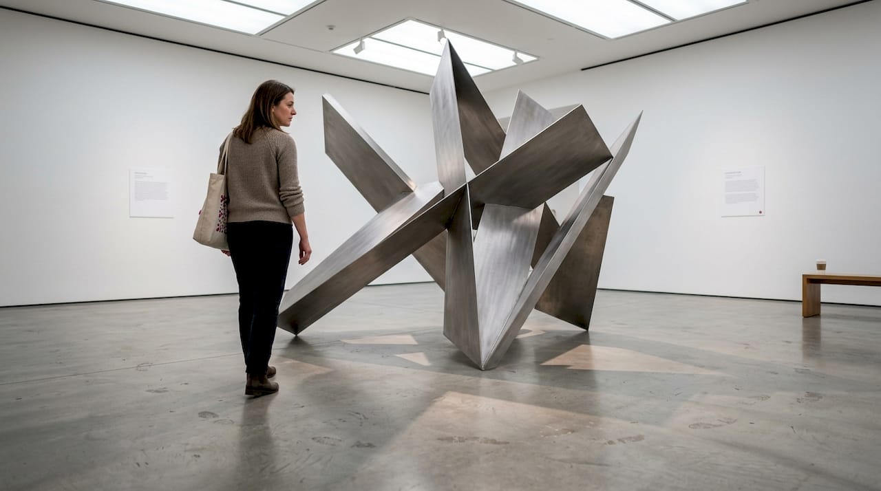 Gallery visitor viewing minimalist sculpture