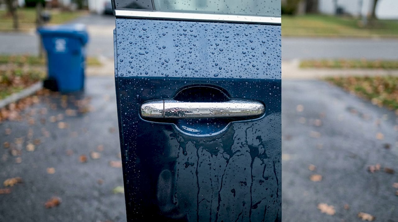 Water beading on car door showing protection