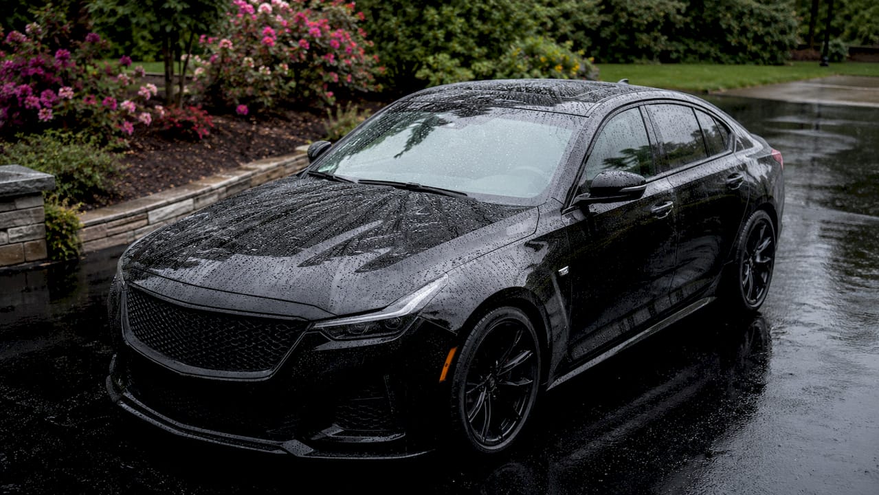 Close-up hydrophobic water beads on car hood