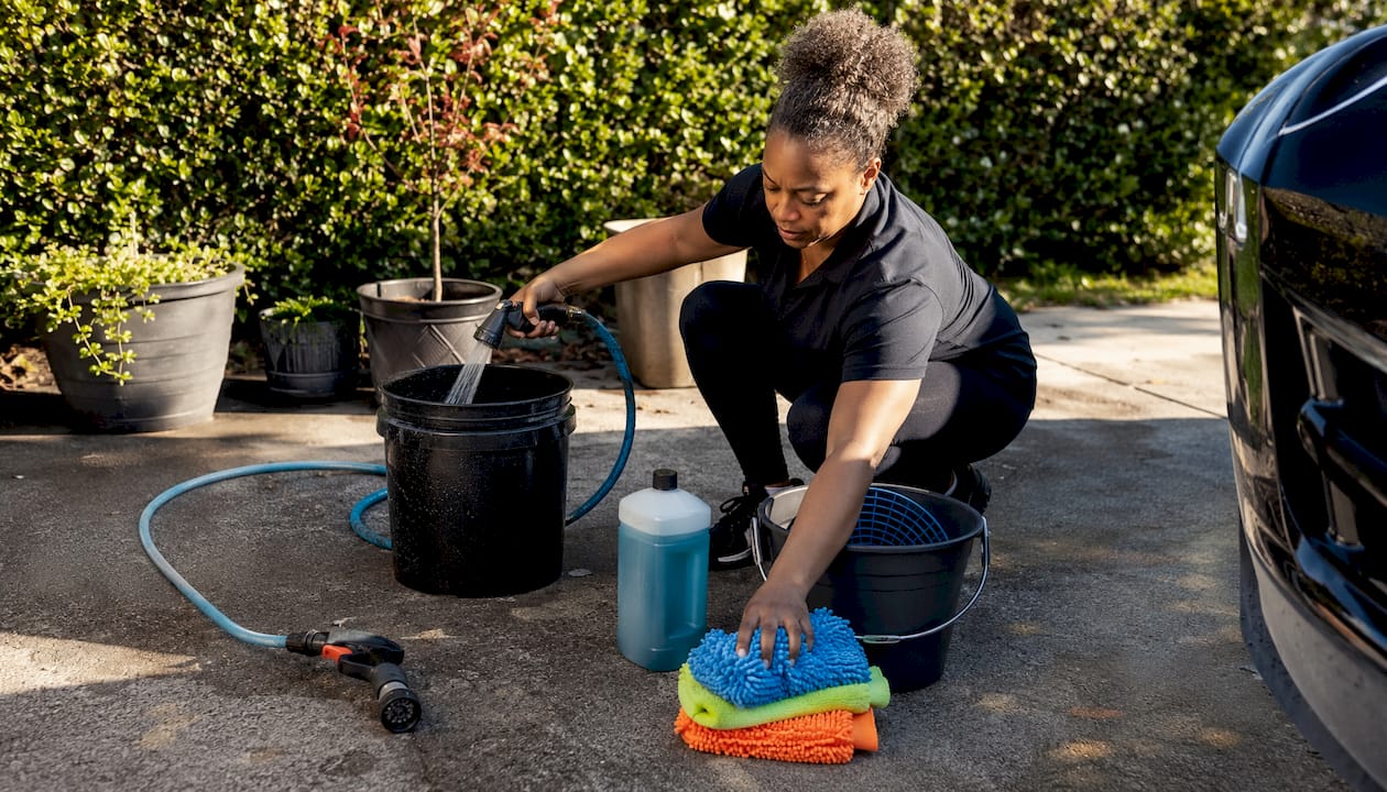 Close-up of woman preparing car wash buckets