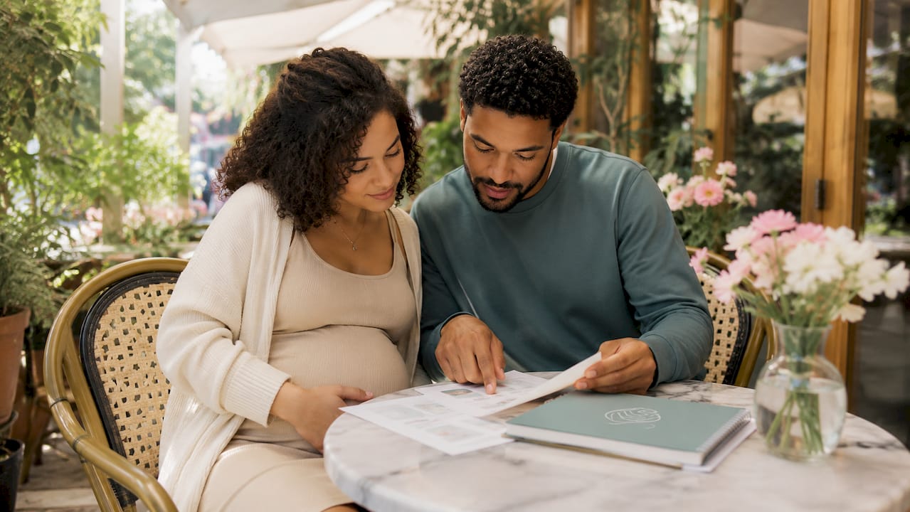 Couple reviewing prenatal care details together