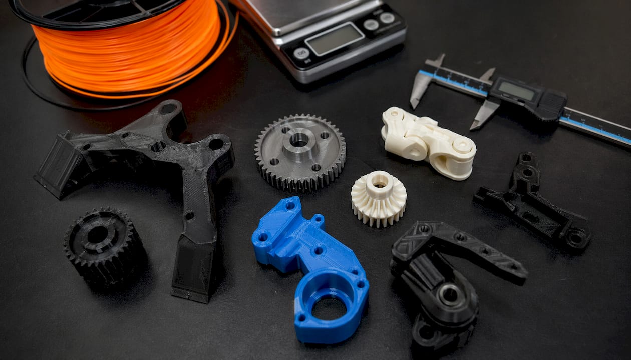 Detailed 3D printed robot parts on workshop table