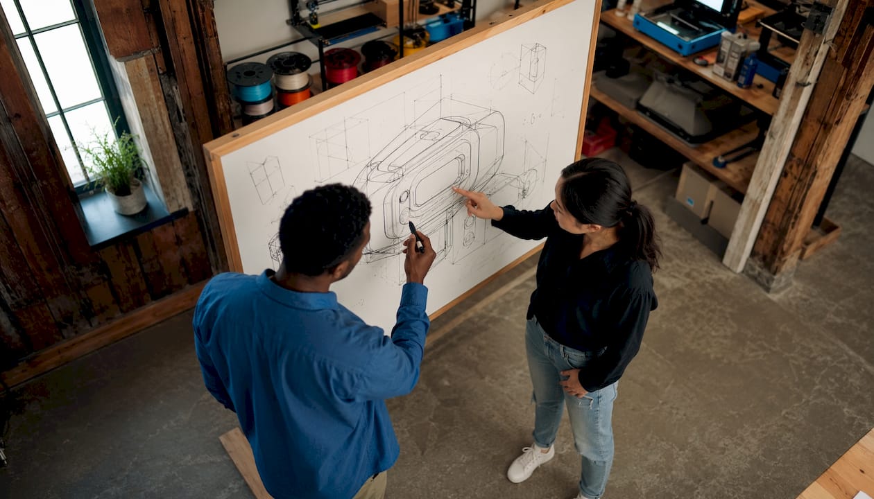 Two design technologists working on CAD model