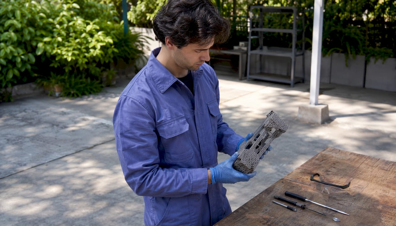 Engineer inspecting complex 3D printed aerospace part