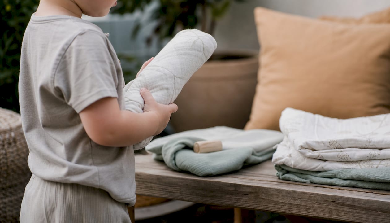Toddler holding diaper near changing table