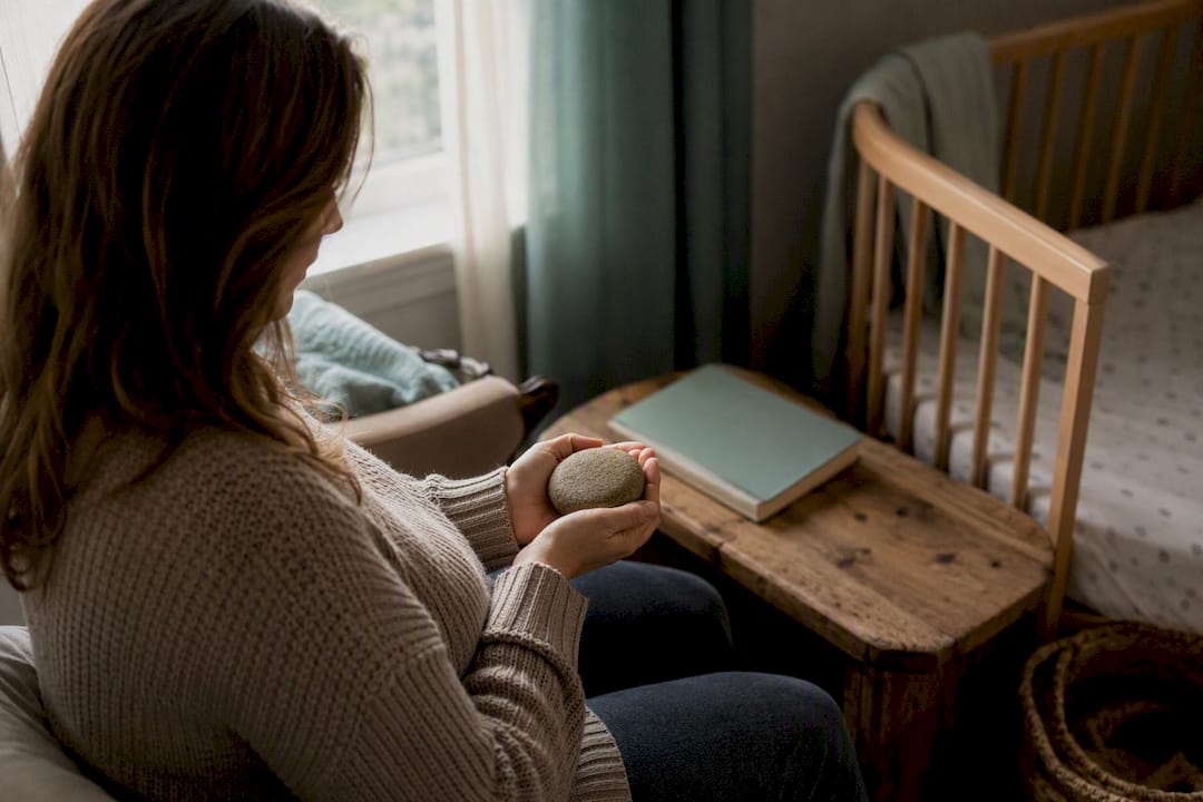 Hands holding symbolic birth recovery object