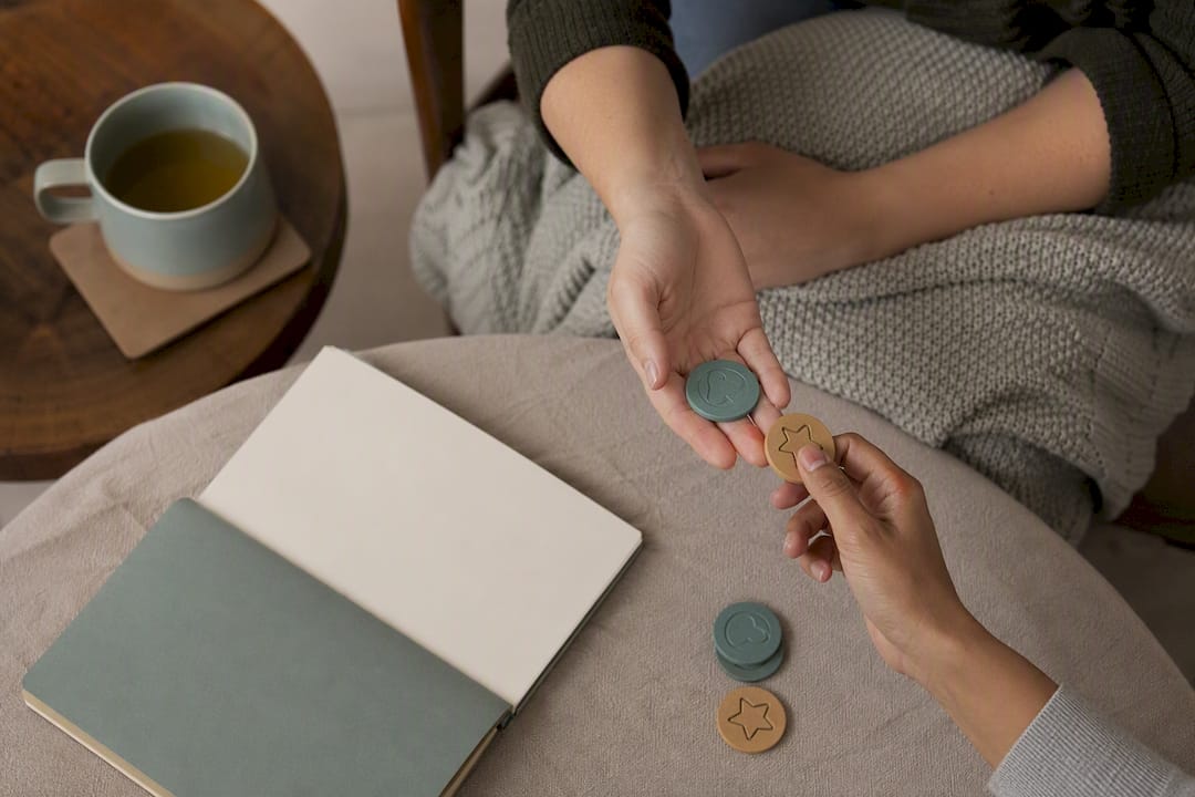 Hands exchanging tokens for behavior trade