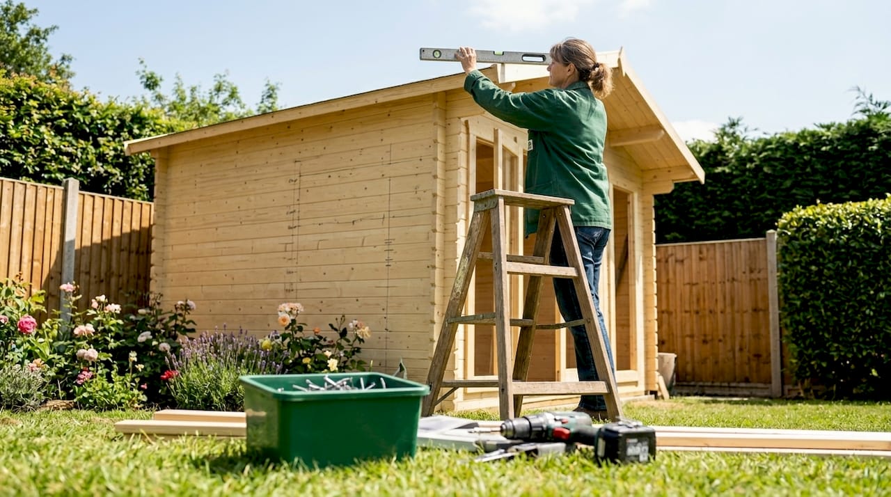Woman measuring apex cabin roof height