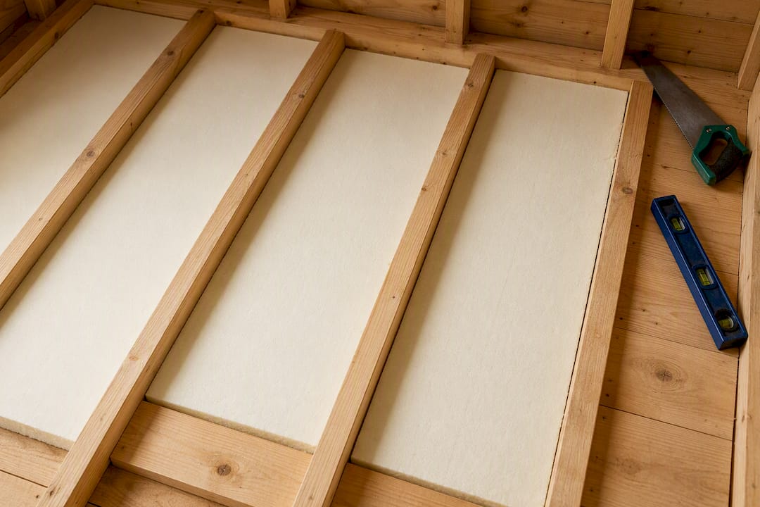 Insulated timber floor joists with rigid board