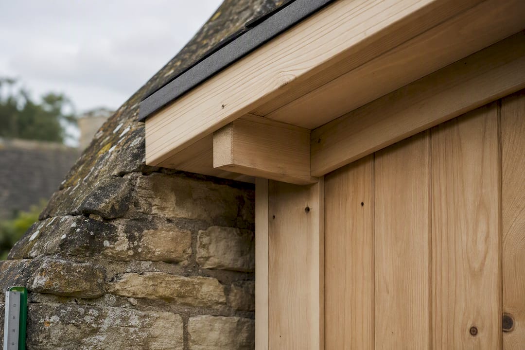 Timber cladding and roof details beside masonry