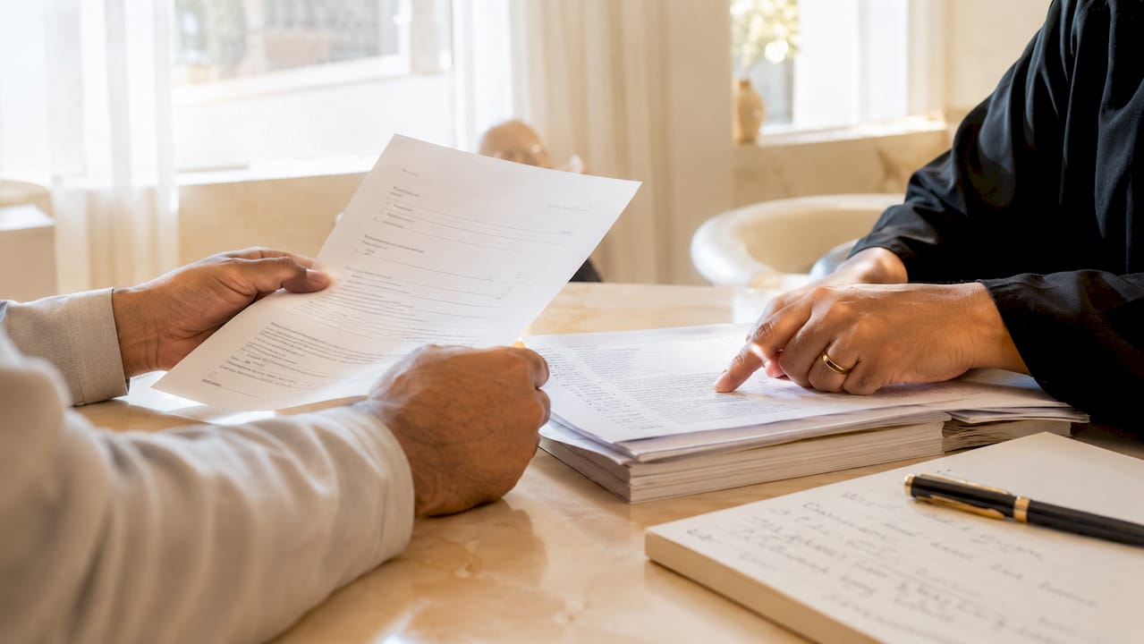 Hands examining essential marriage registration documents