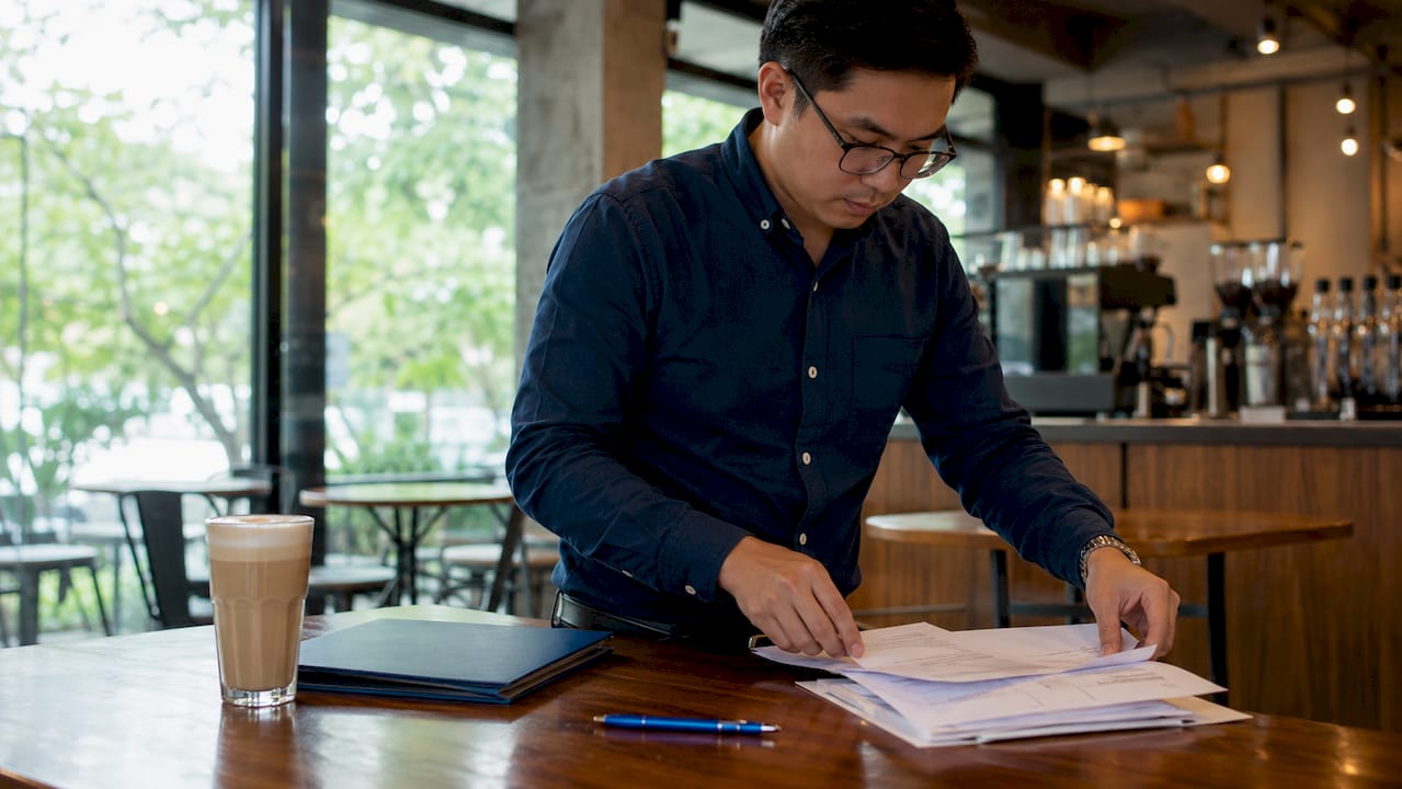 Filipino man organizing documents for UAE attestation